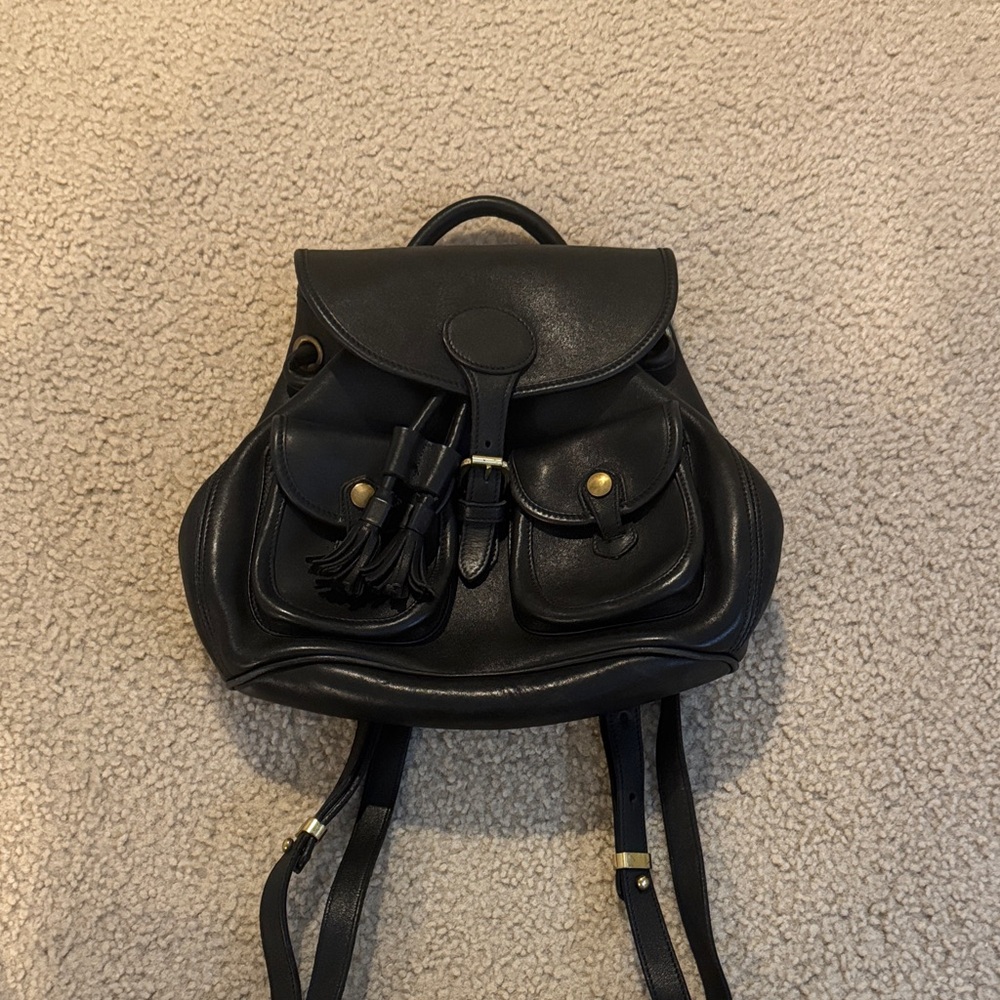 Dooney & Bourke Black Leather Backpack with gold accents